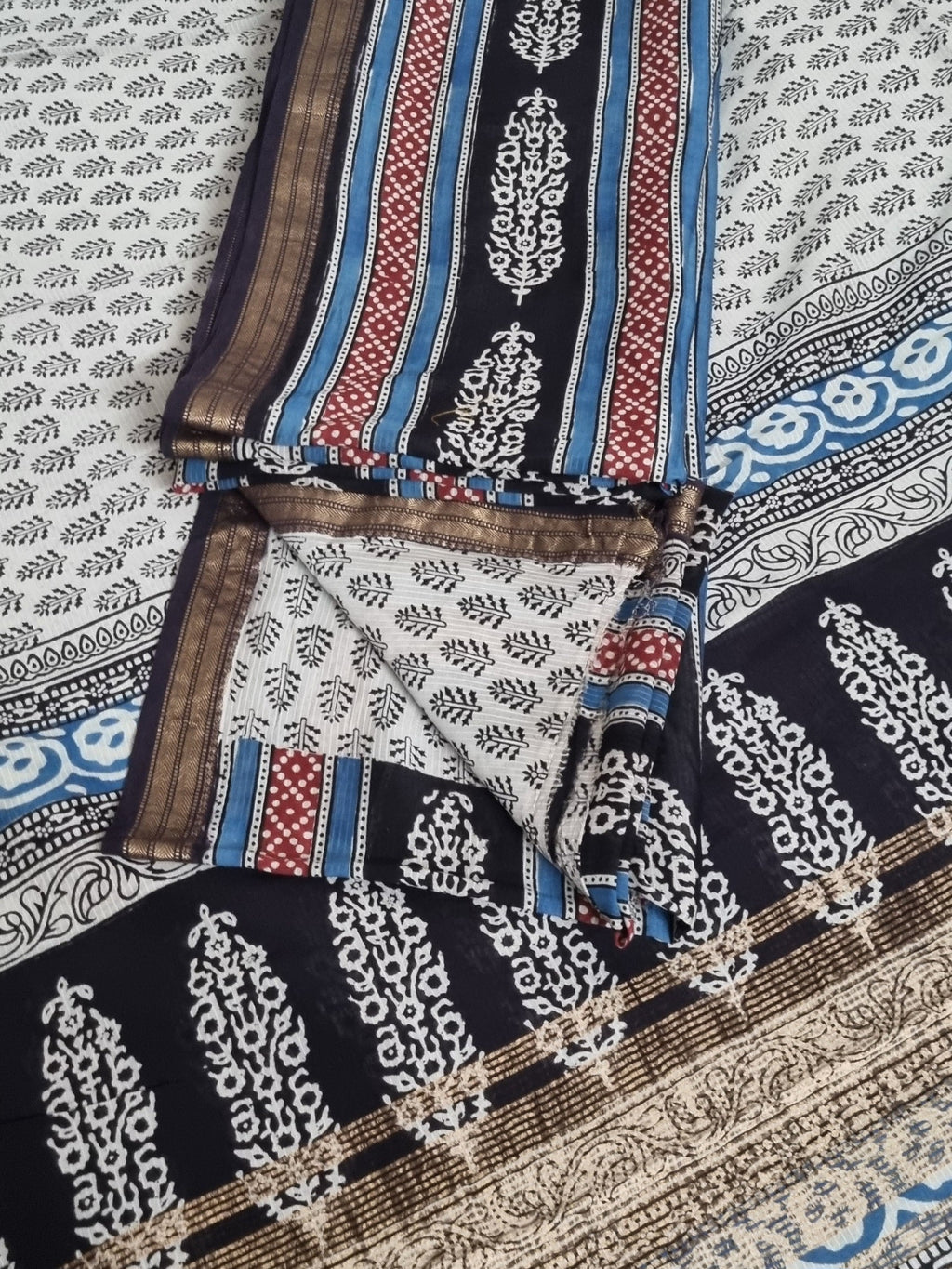 Close-up of Bagh hand block printed Maheshwari silk fabric in black and blue tones