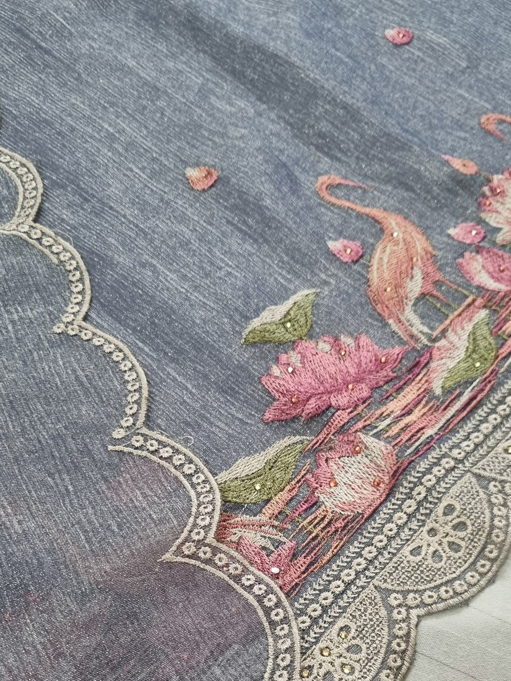 Close-up – handloom silk tissue fabric texture with floral embroidery