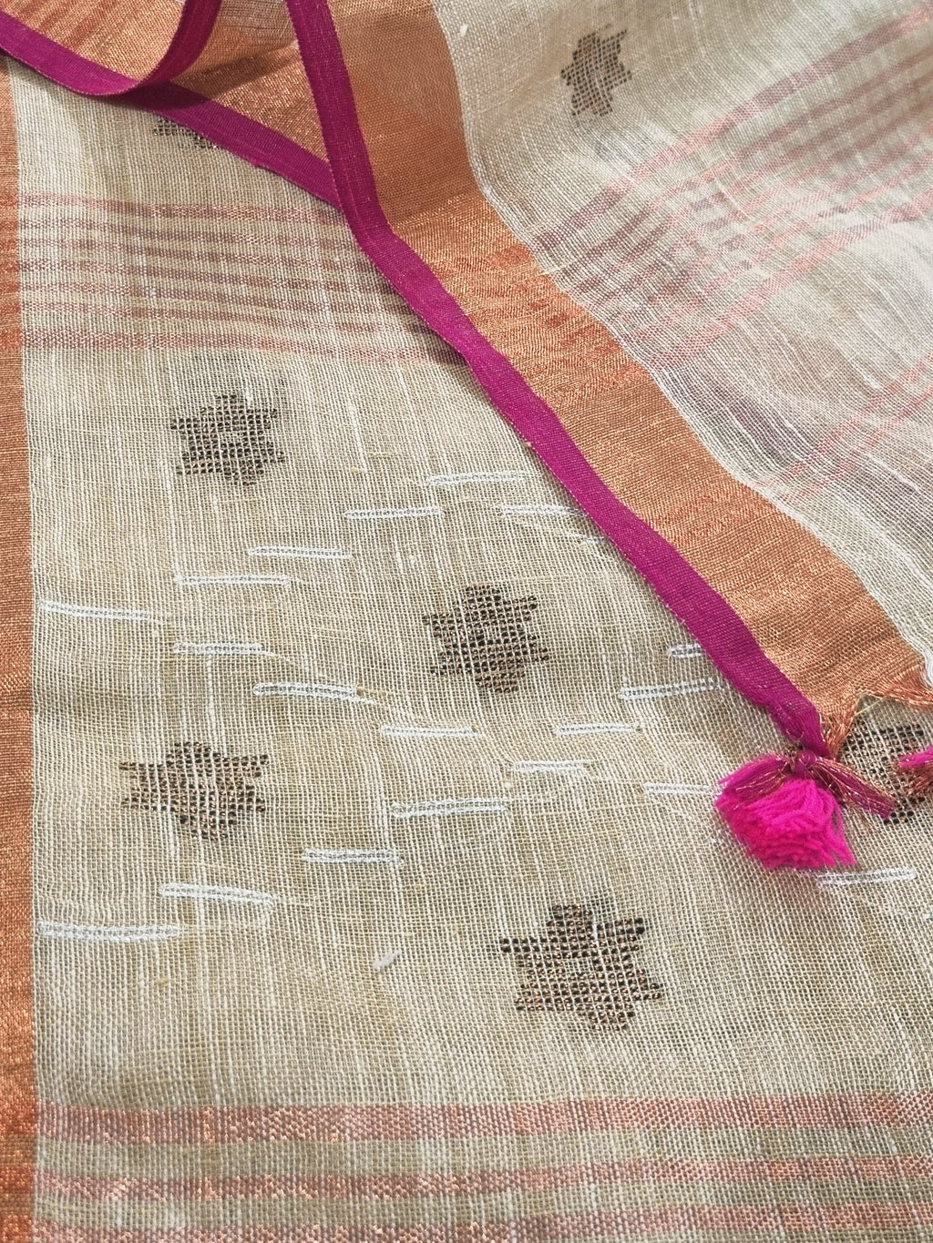 Indian handloom Jamdani linen fabric close-up – oatmeal base with woven metallic stars