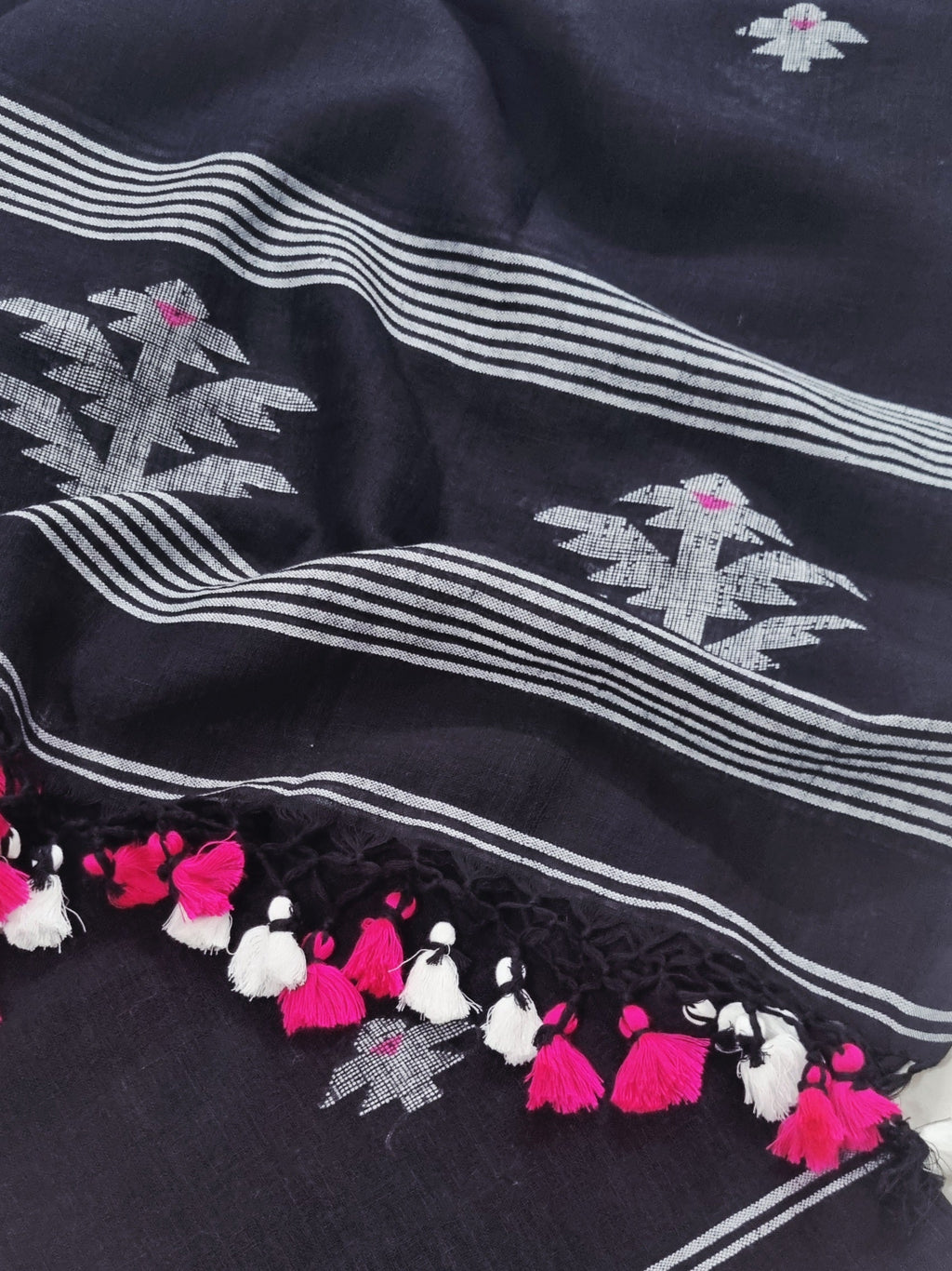 Black handloom linen suit fabric with traditional woven motifs – close-up detail view
