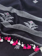 Black handloom linen suit fabric with traditional woven motifs – close-up detail view