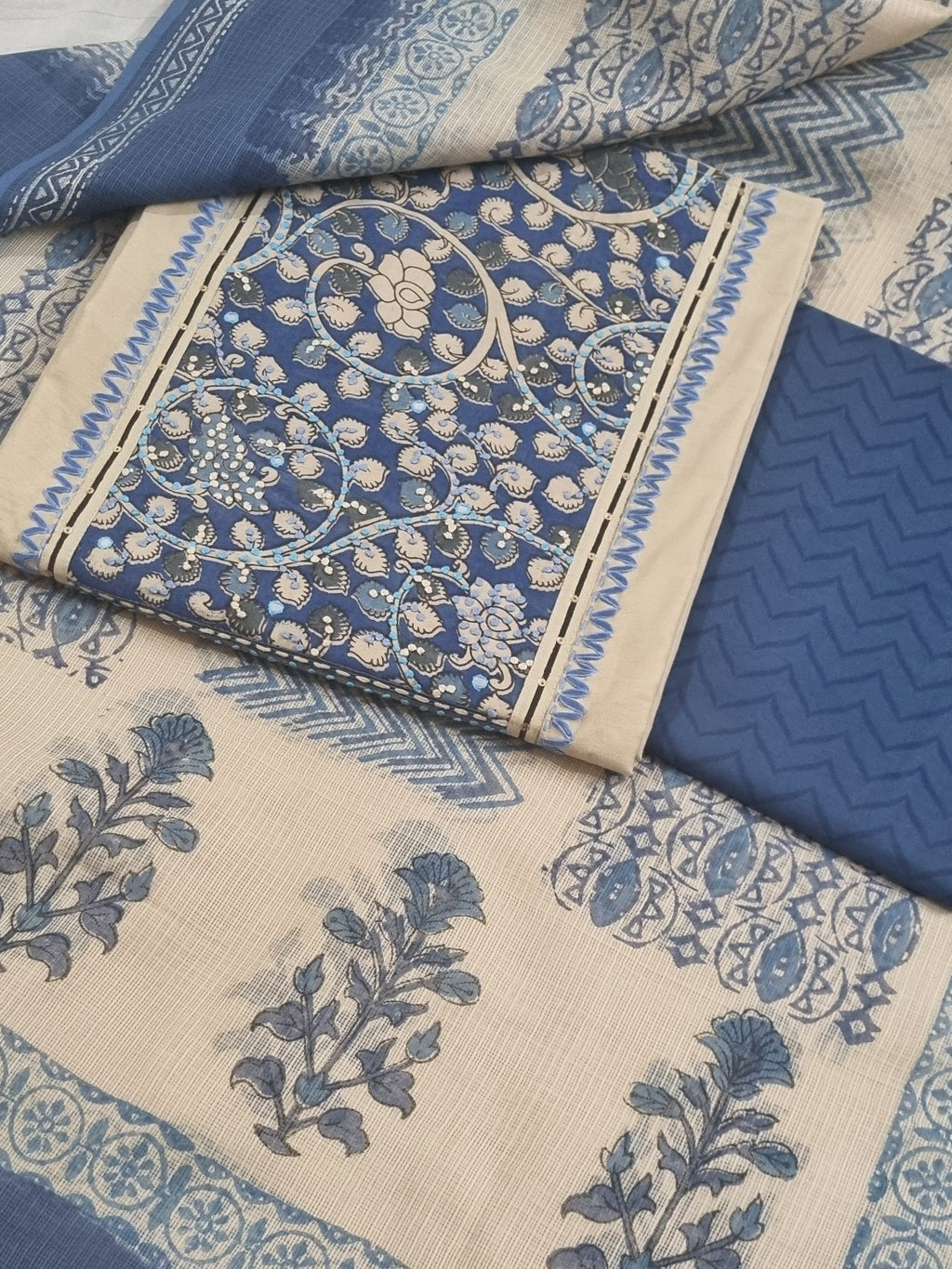 Taupe unstitched suit set with blue patched neckline and Kota Doria dupatta – close-up detail 