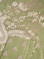 Flat lay of elaichi green Banarasi unstitched suit set — Karwa Booti handwoven Indian handloom fabric