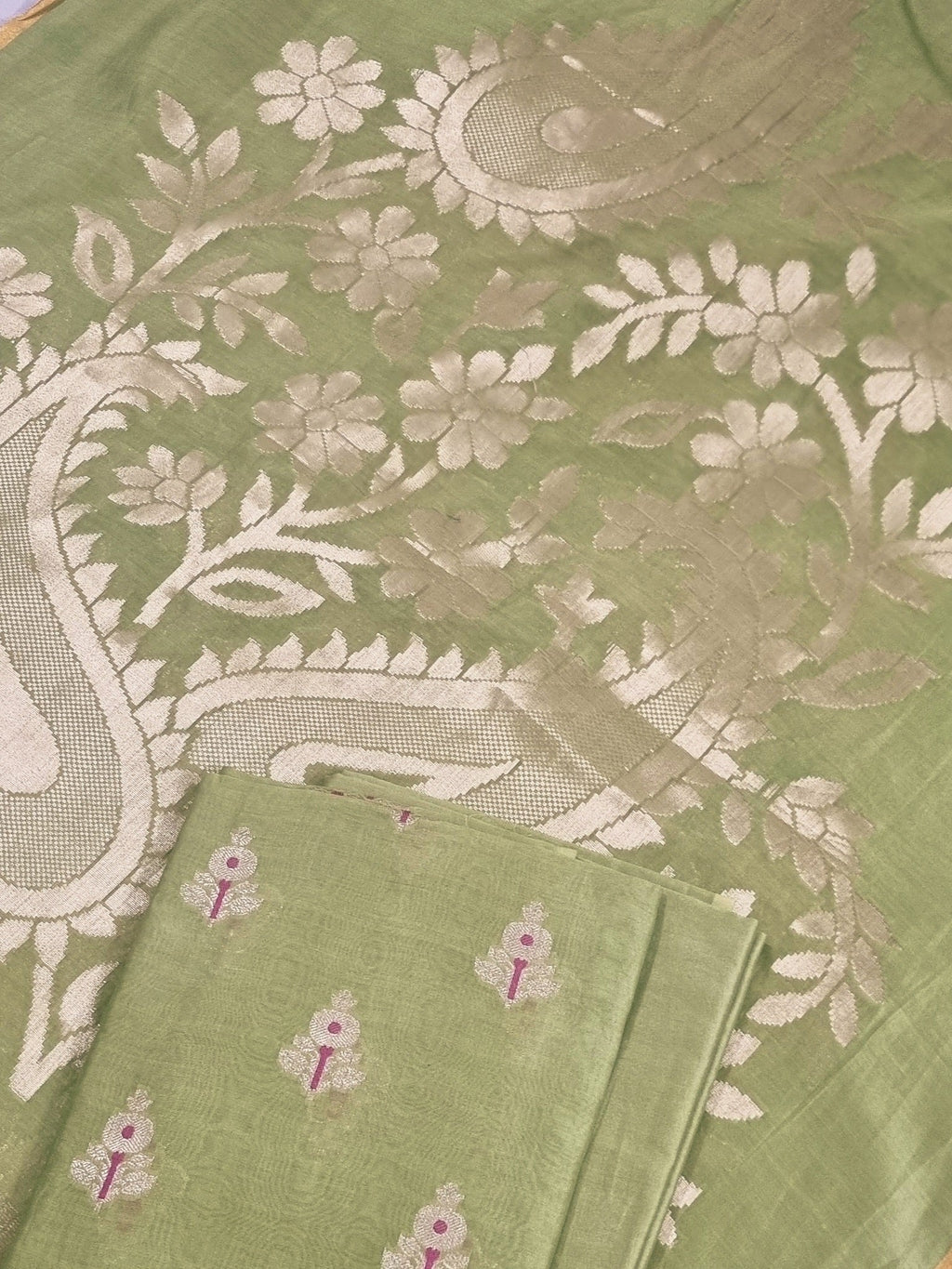 Flat lay of elaichi green Banarasi unstitched suit set — Karwa Booti handwoven Indian handloom fabric