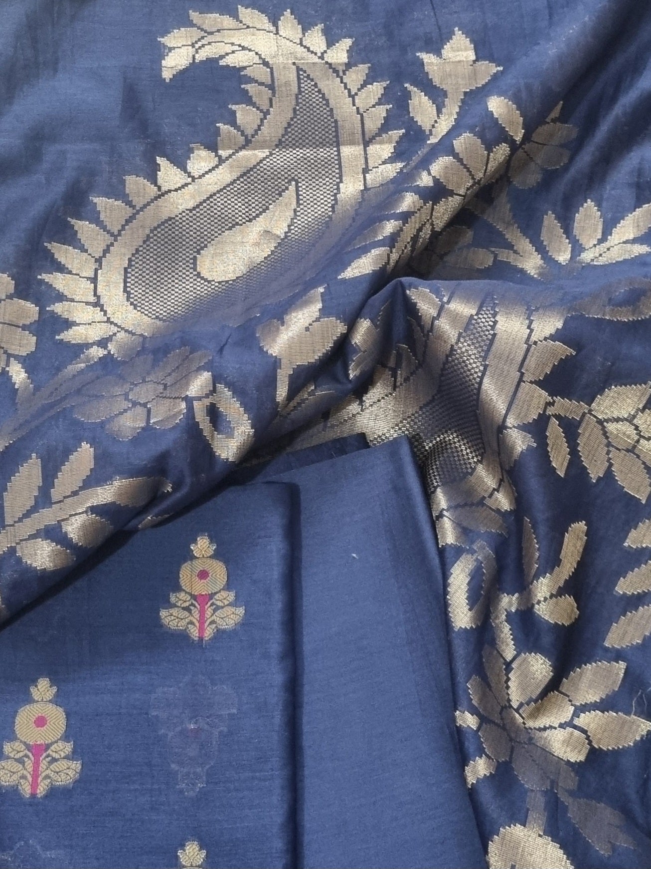 Close-up of Karwa Booti woven motif on blue Banarasi unstitched suit fabric