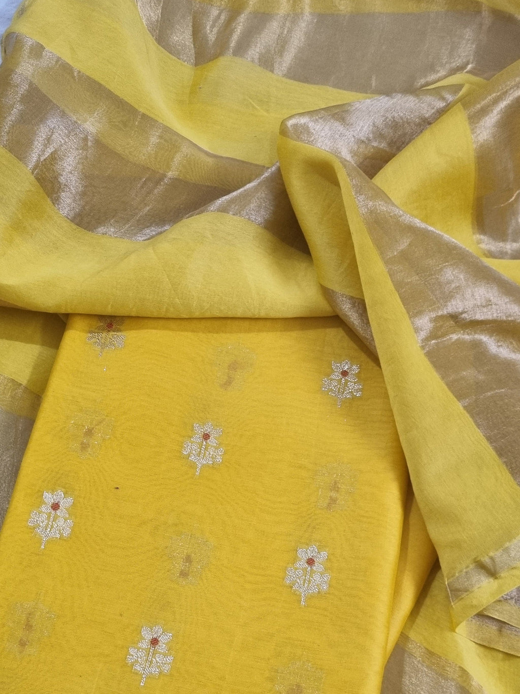 Close-up of Karwa Booti weave on yellow Banarasi unstitched suit — handwoven Indian textile
