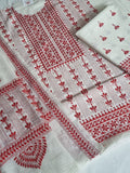 Close-up of red Kantha embroidery motifs on cream cotton kurta fabric