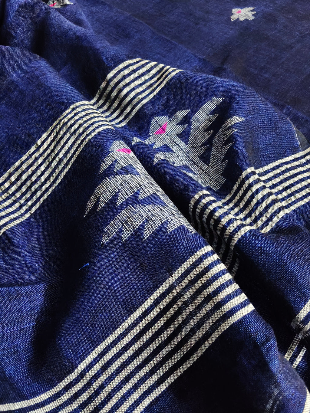 Deep indigo blue handloom linen fabric with traditional woven motifs – close-up texture detail, unstitched suit material