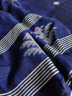 Deep indigo blue handloom linen fabric with traditional woven motifs – close-up texture detail, unstitched suit material