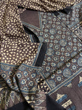 Close-up of brown Ajrakh hand block printed cotton kurta fabric with indigo blue medallion motifs and matching dupatta with geometric print