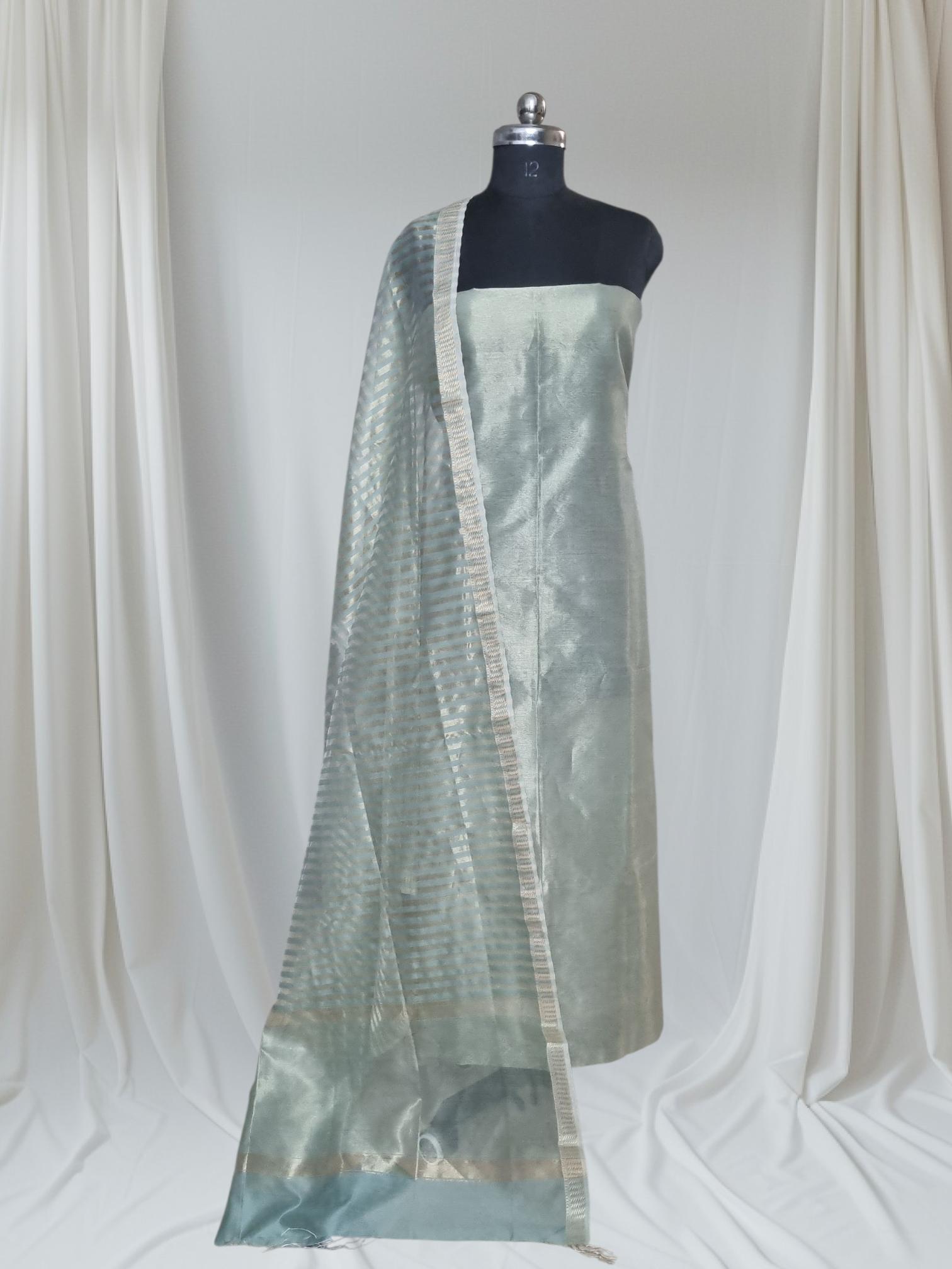 Styled flat lay of powder green Maheshwari Silk Zari 2-piece unstitched suit – lightweight handloom ethnic wear