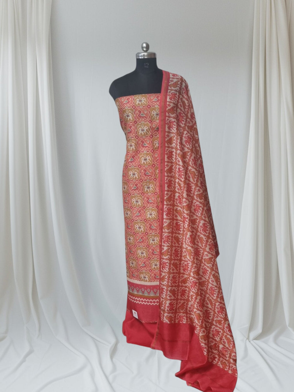 Chanderi Silk Patola print unstitched suit set in red green orange – editorial portrait
