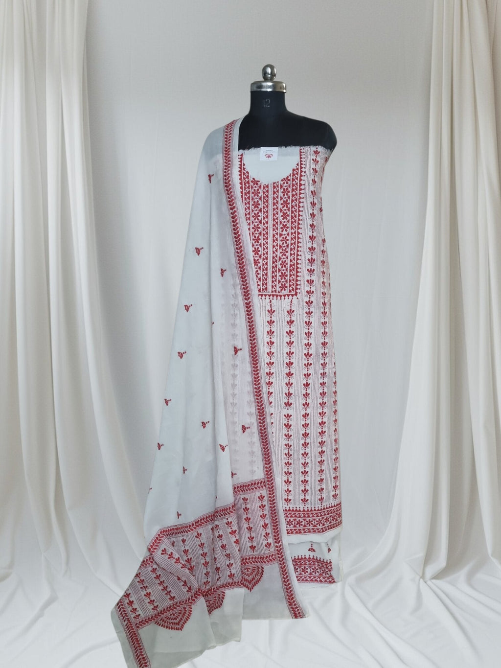 Red and cream hand-embroidered Kantha cotton suit set – styled flat lay