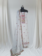 Red bird Parsi Gara hand-embroidered cotton suit set – editorial portrait styling