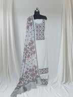Cream red green Sindhi hand-embroidered cotton suit set – editorial portrait styling