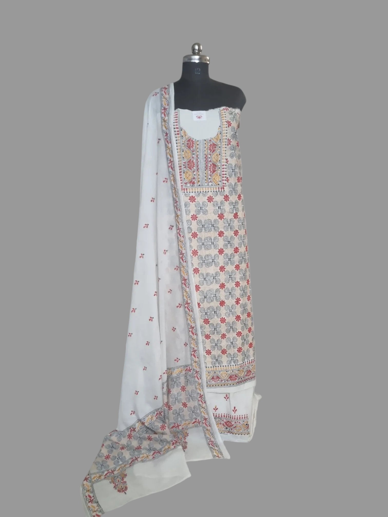 fully adorned with multicolour Kantha patterns on breathable cream cotton.