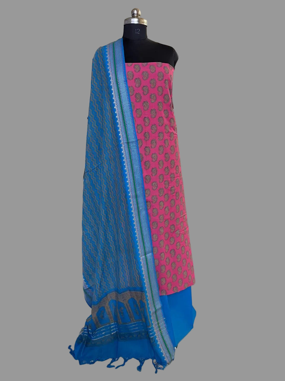 Blue and pink handloom cotton unstitched suit set on mannequin — pink kurta with woven paisley motifs, blue salwar, and blue dupatta with woven temple border and tassel edge