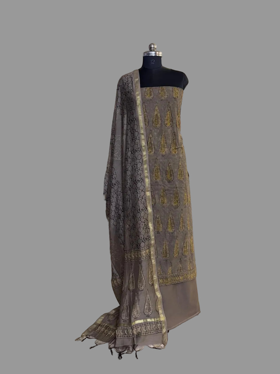 Khaki Ajrakh cotton hakoba kurta set with Chanderi silk dupatta draped on mannequin, featuring Ajrakh block print and gold zari border