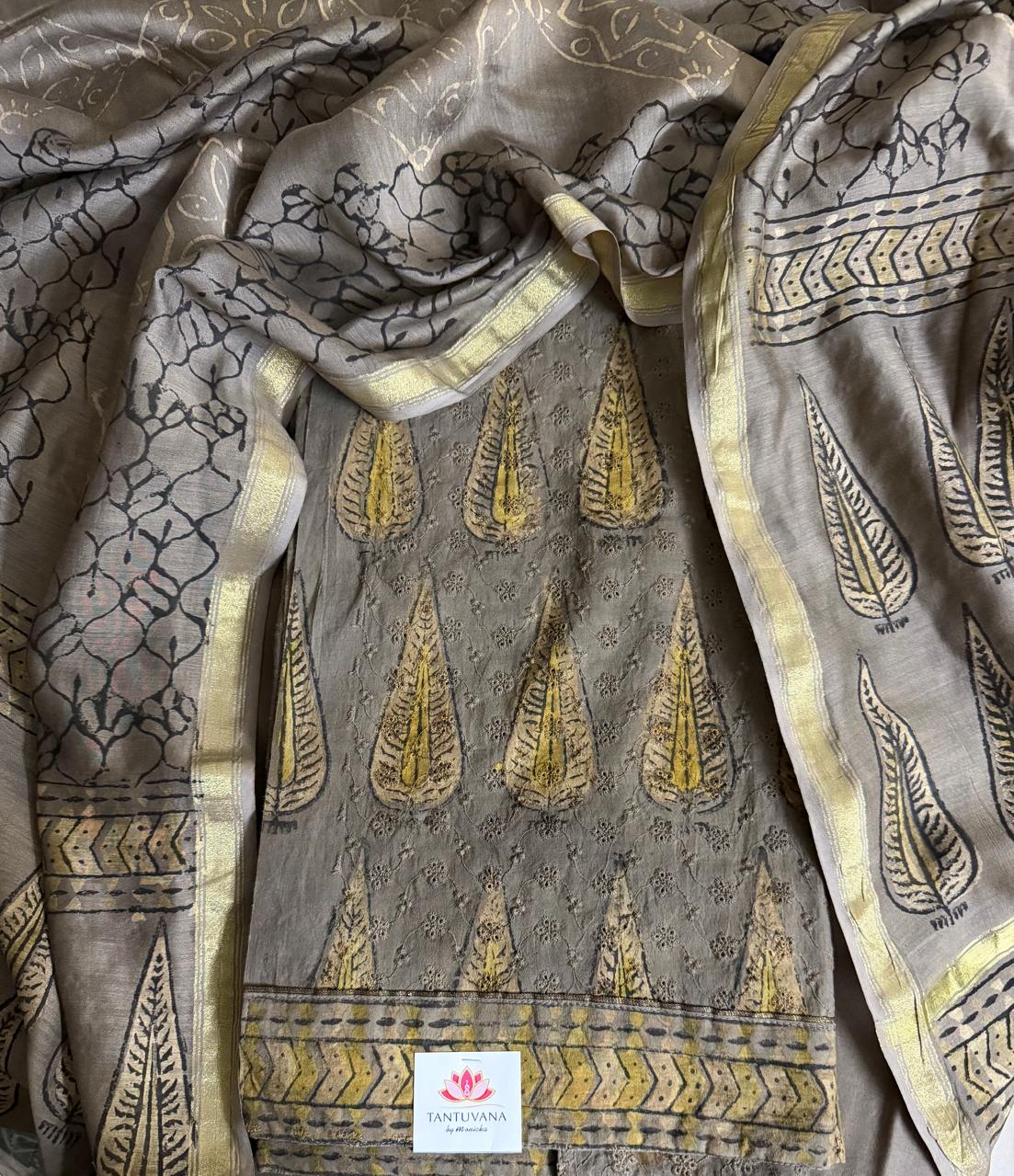 Close-up flat lay of khaki Ajrakh cotton hakoba kurta with large gold paisley motifs and Chanderi silk dupatta with Ajrakh print and zari border