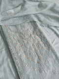 Powder green Chanderi silk unstitched kurta fabric with pita work embroidery and floral motifs, flat lay with dupatta