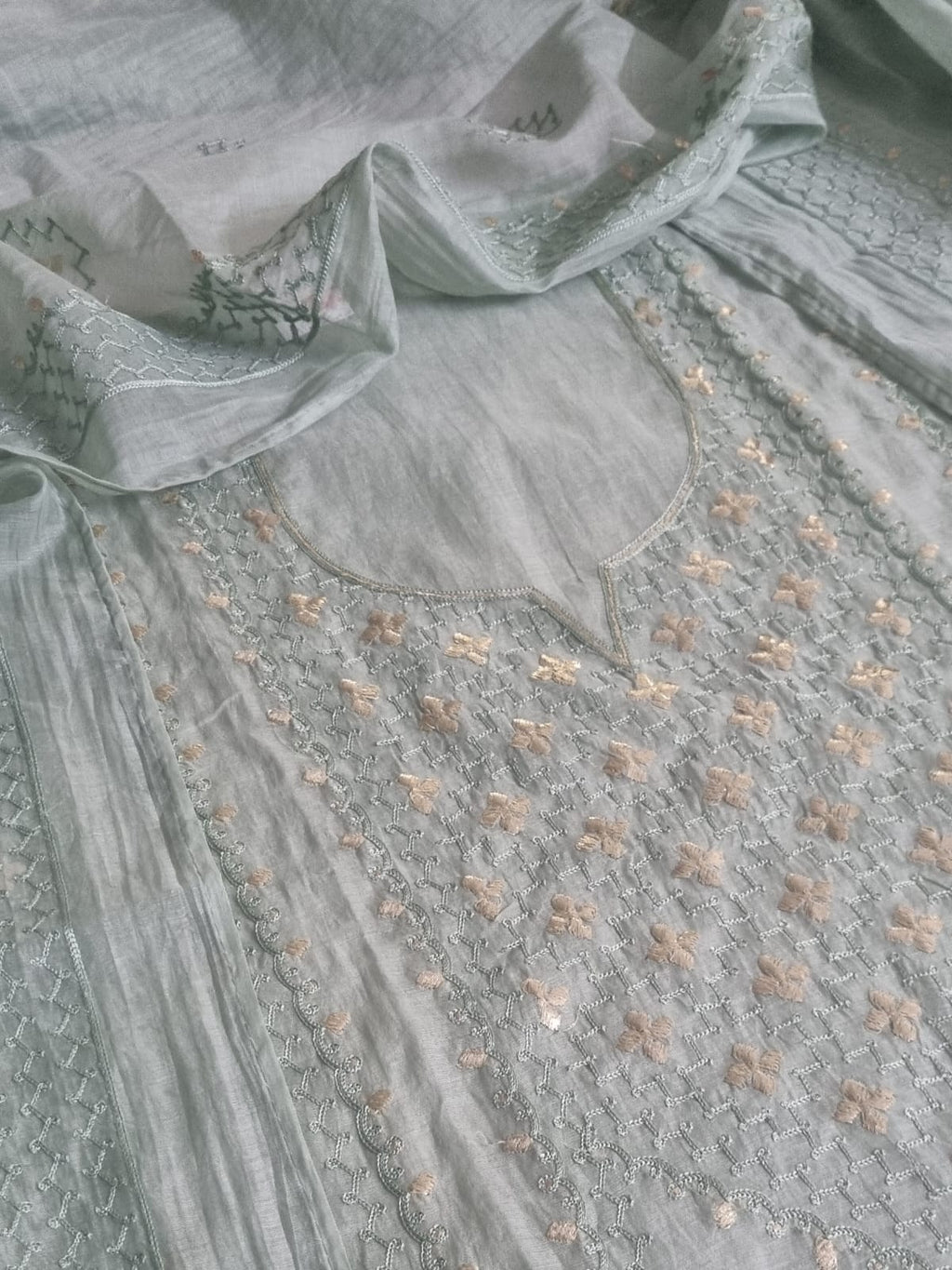 Flat lay close-up of powder green Chanderi silk kurta yoke with pita work floral embroidery and silver thread jaal weave