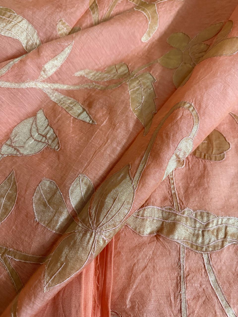 Close-up of peach beige Chanderi silk dupatta with large gold silk tissue appliqué lotus, leaf and botanical floral motifs