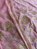 Pink Chanderi silk unstitched suit fabric with gold appliqué dahlia and floral motifs, dupatta border visible alongside