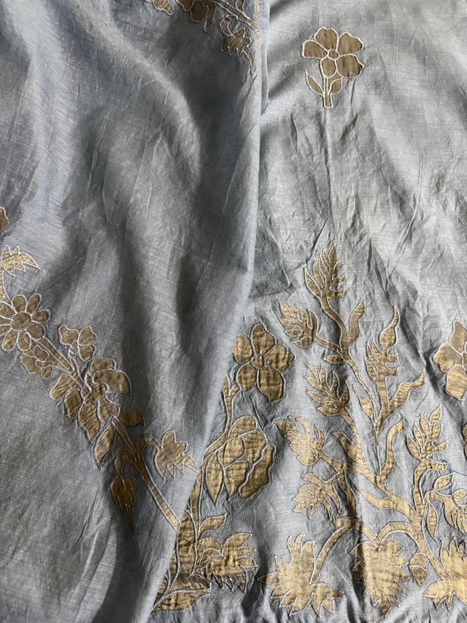 Close-up of grey Chanderi silk dupatta with dense gold appliqué floral, bud and leaf border embroidery detail