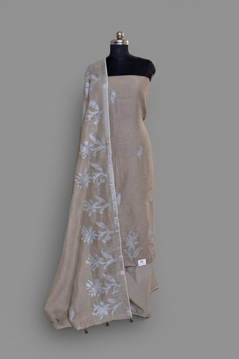 Taupe linen 3-piece unstitched suit set displayed on mannequin with white appliqué floral dupatta draped over shoulder