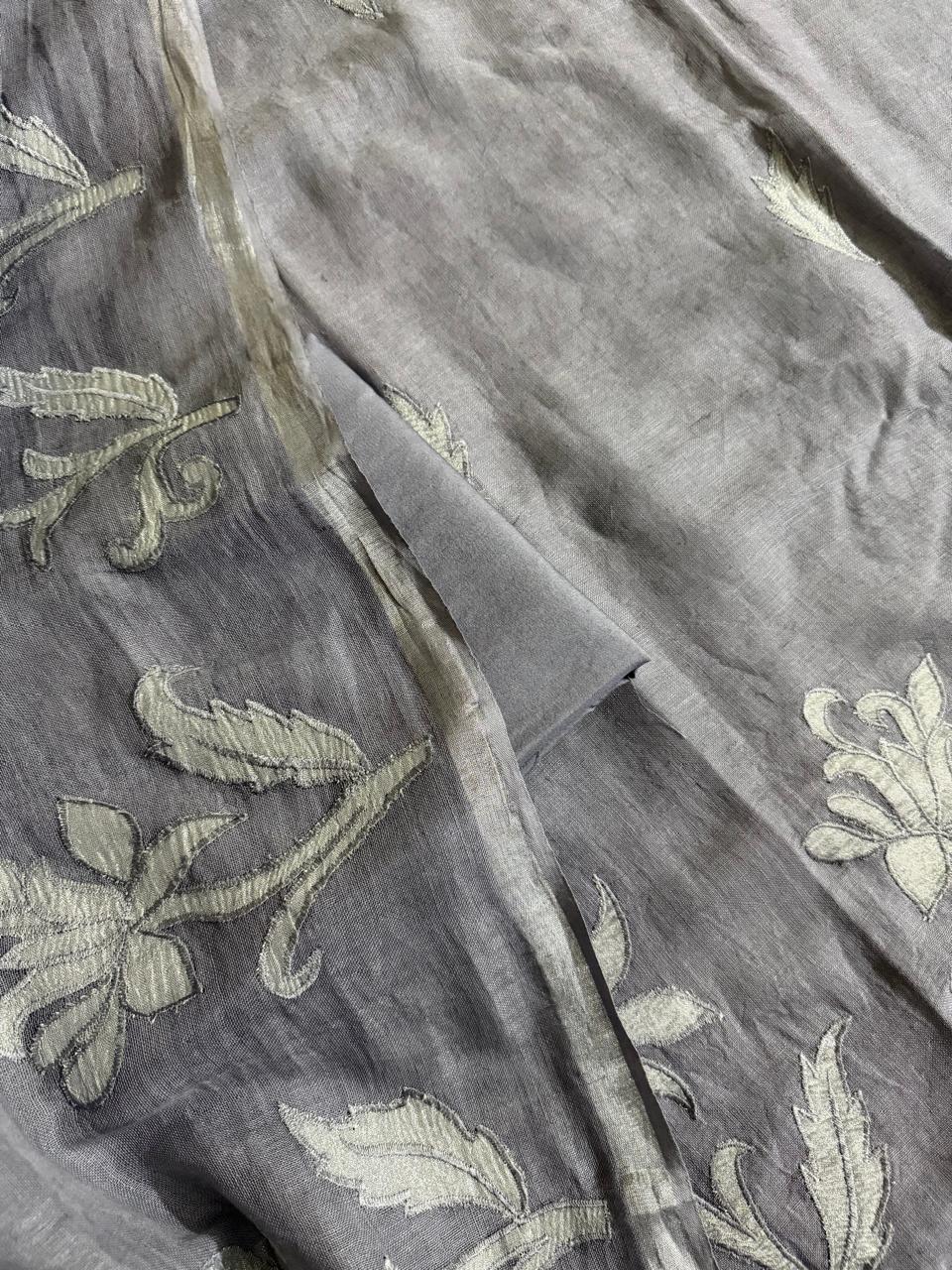 Close-up of grey linen dupatta with silver silk tissue appliqué botanical floral and leaf motifs scattered across fabric