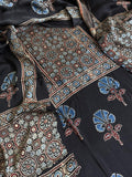 Flat lay of black Ajrakh Modal silk kurta dupatta set showing blue and maroon geometric medallion yoke panel, scattered blue glory lily floral body print and dupatta
