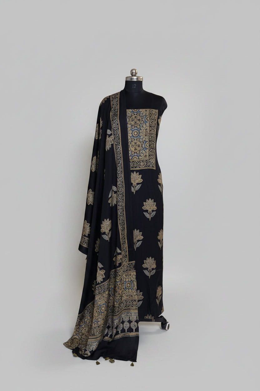 Black modal silk Ajrakh block print kurta dupatta set on mannequin with blue and gold medallion yoke, large lotus body print and ornate border dupatta with tassels