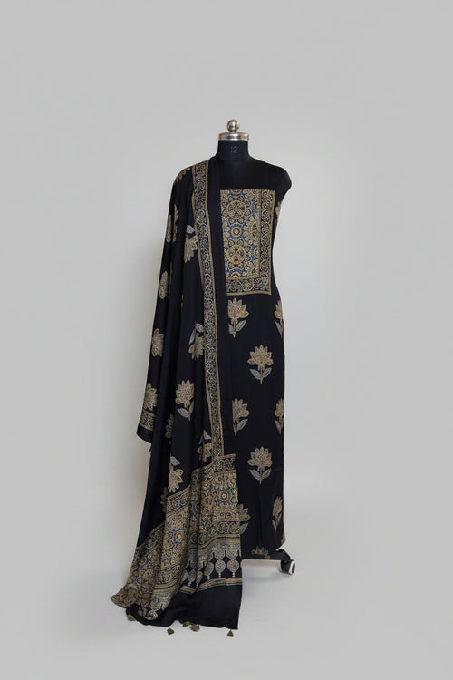 Black modal silk Ajrakh block print kurta dupatta set on mannequin with blue and gold medallion yoke, large lotus body print and ornate border dupatta with tassels