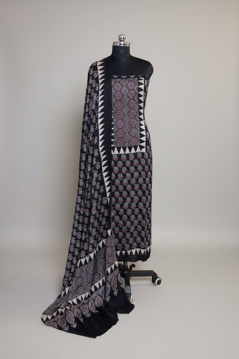 Black modal silk Ajrakh block print kurta dupatta set on mannequin with geometric diamond yoke, floral body print and triangle border dupatta