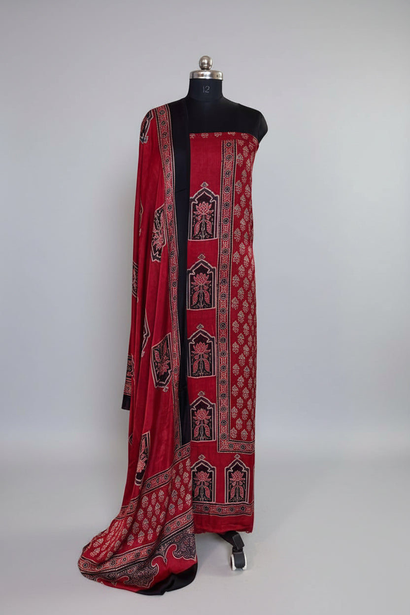 Red and black Ajrakh Modal silk 2-piece kurta dupatta set on mannequin with black arch lotus panel kurta border, red floral body and matching paisley dupatta