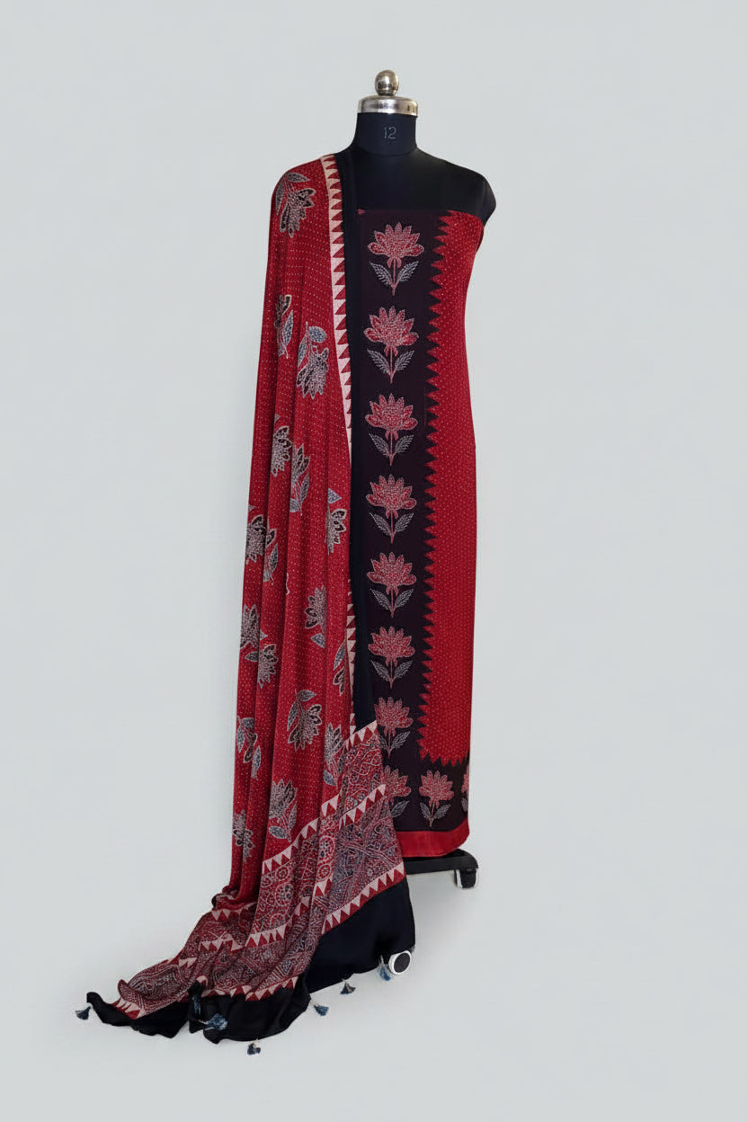 Red and black Ajrakh Modal silk 2-piece kurta dupatta set on mannequin with black zigzag floral kurta panel, red polka dot body and paisley dupatta with tassels