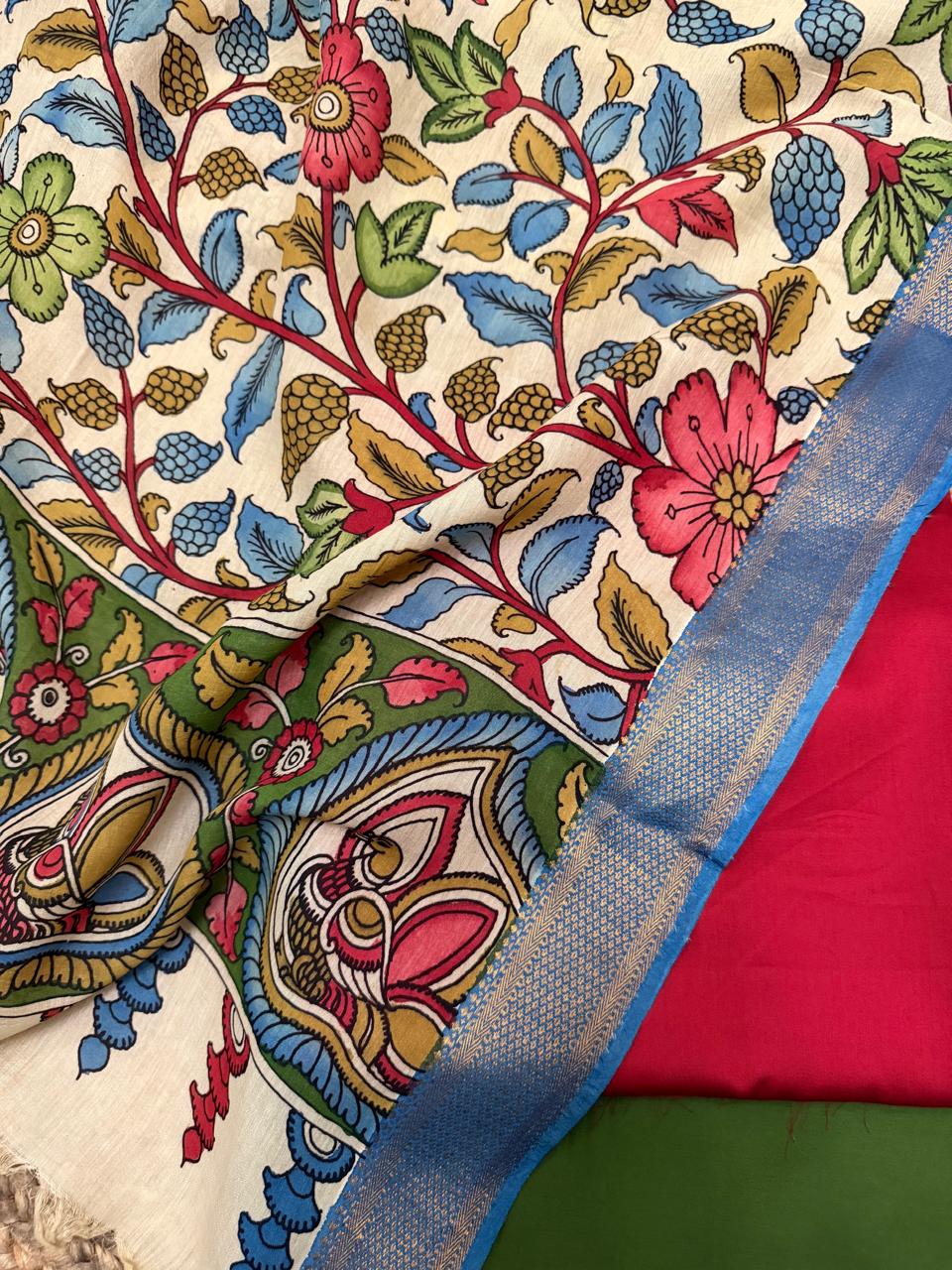 "Unstitched 3-piece suit set with hand-painted Pen Kalamkari dupatta, red top fabric and forest green bottom – traditional Indian handloom wear"