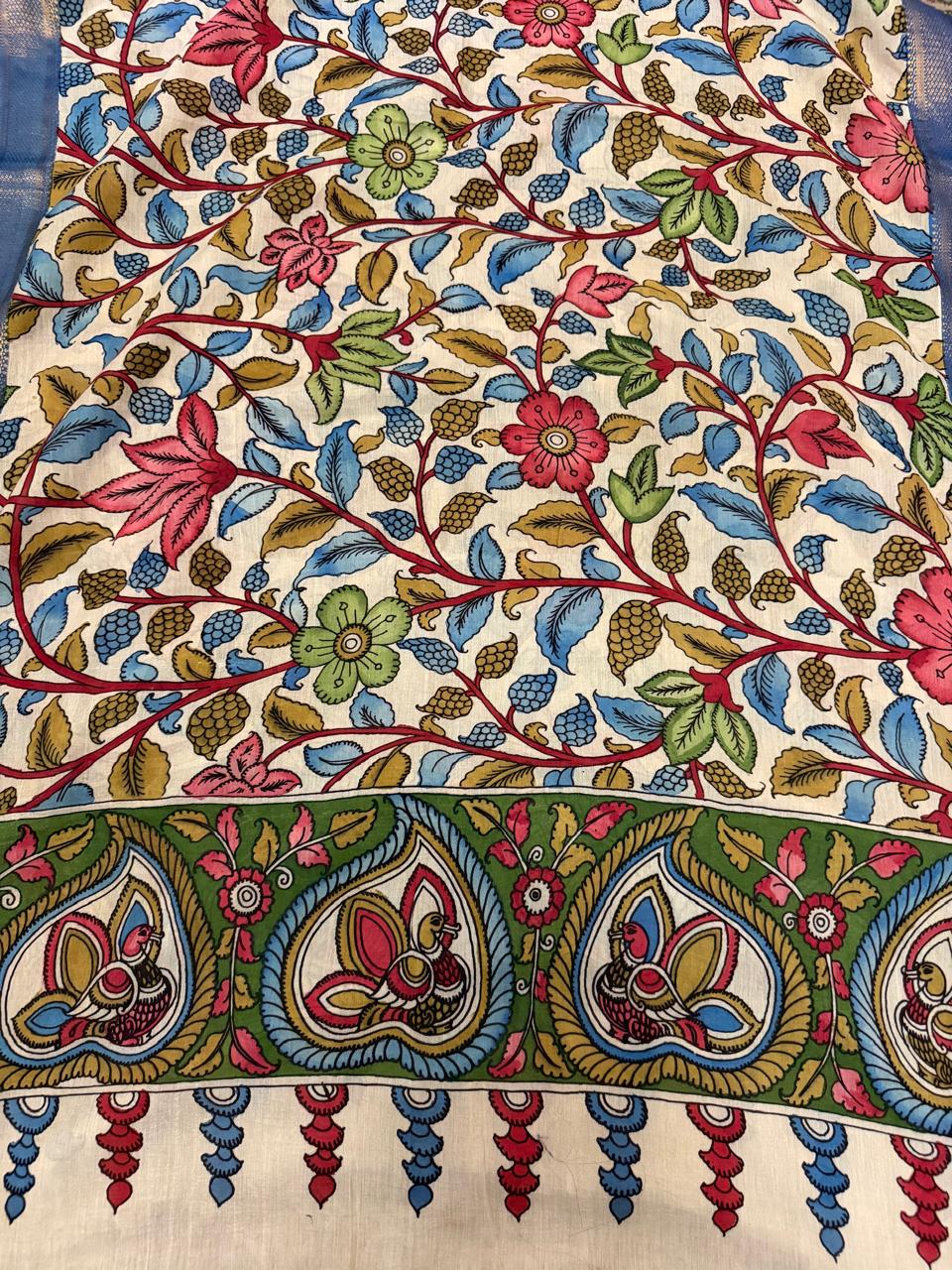Close-up of hand-painted Pen Kalamkari dupatta body – dense floral vine pattern in pink, blue, and green on ivory Mangalgiri pattu silk with peacock-motif border
