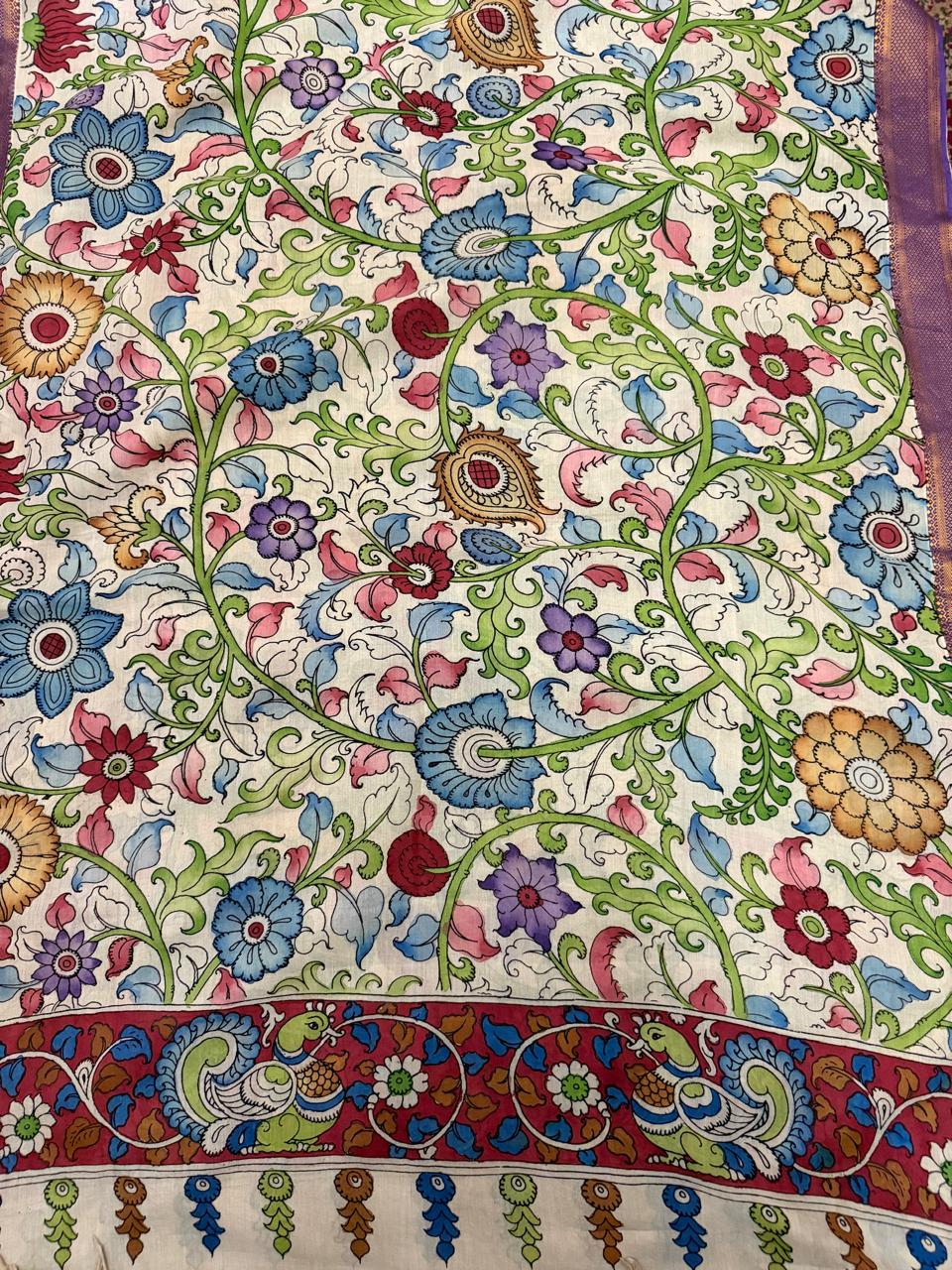 Full spread of hand pen Kalamkari dupatta body – dense multicolour floral vine with blue, pink, crimson and purple flowers on ivory Mangalgiri silk, peacock-pair border on maroon ground with tassel fringe