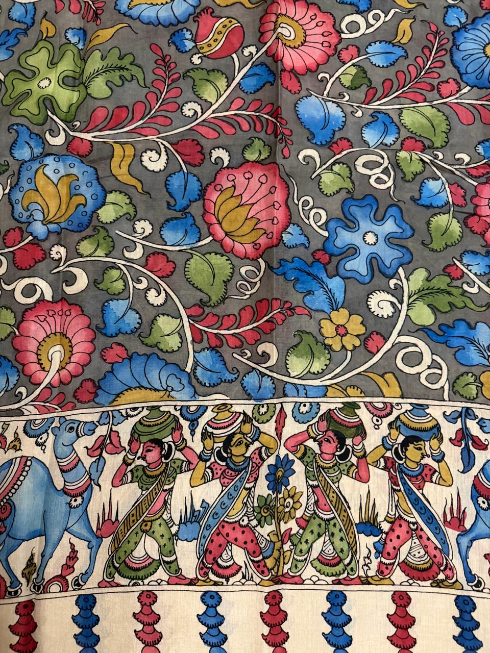 Macro close-up of hand painted Kalamkari dupatta body – dense pink lotus, blue floral vine, and green foliage on grey ground with white scroll, transitioning to ivory border with gopi and animal procession