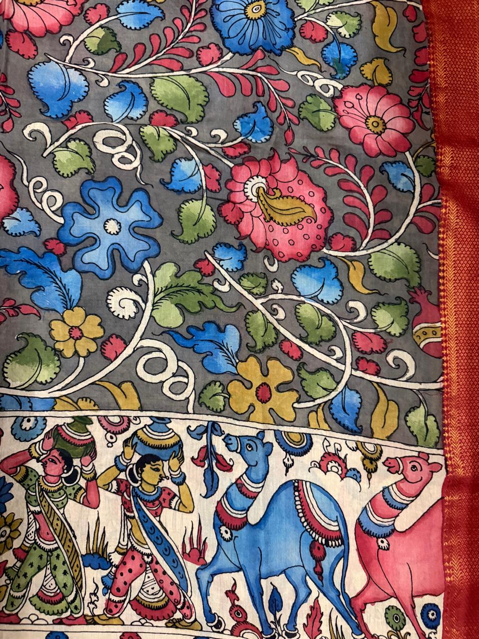 Close-up of hand painted Kalamkari dupatta body and mythological pallu border – grey ground pink and blue floral vine above ivory border with gopi figures, blue camel, and pink animal, red-gold Zari edge