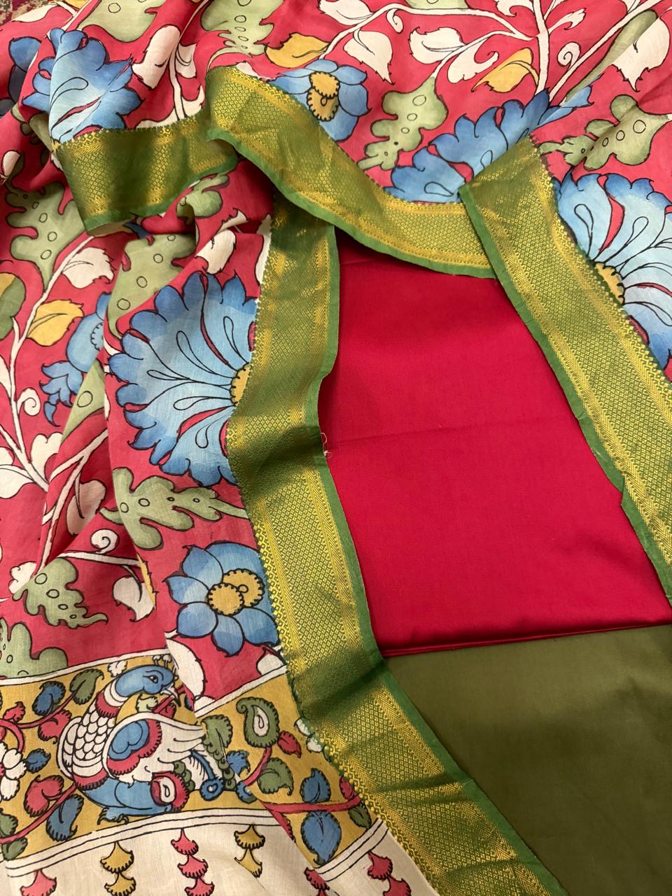 Hand pen Kalamkari dupatta with red and forest green cotton silk 3-piece unstitched suit set – flat lay overview, crimson red floral vine dupatta with gold Zari border, House of Tantuvana