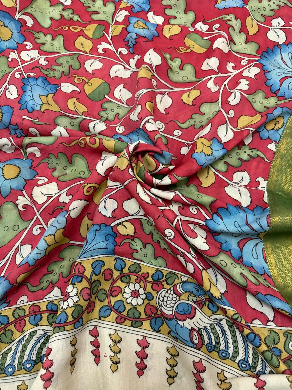 Draped close-up of hand pen Kalamkari dupatta body and border – dense blue, green and yellow floral vine on crimson red ground, yellow-gold peacock pair border with tassel fringe, Mangalgiri silk