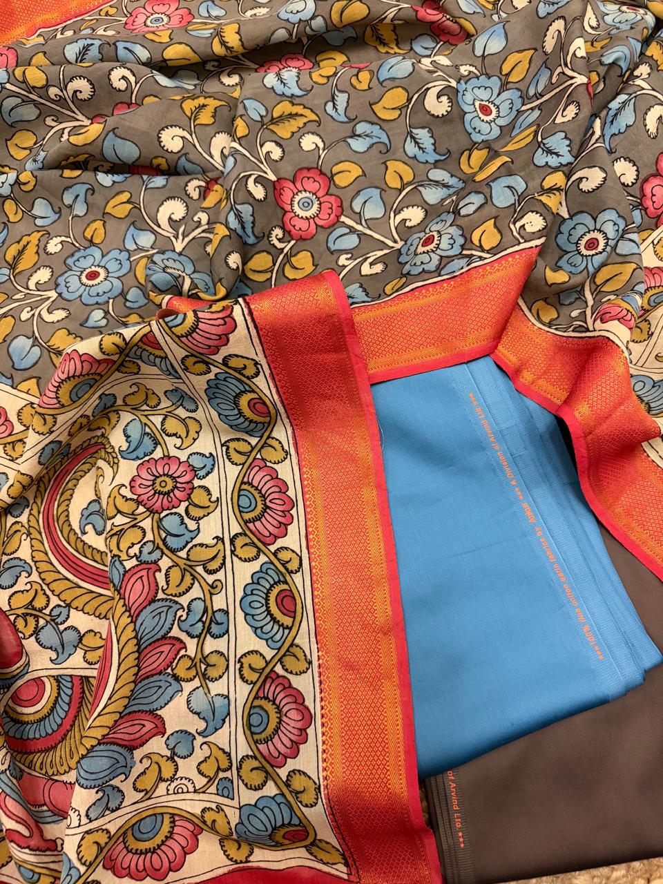 Hand painted Kalamkari dupatta with state blue and charcoal brown cotton silk 3-piece unstitched suit set – flat lay overview with grey floral body and ivory peacock pallu, House of Tantuvana