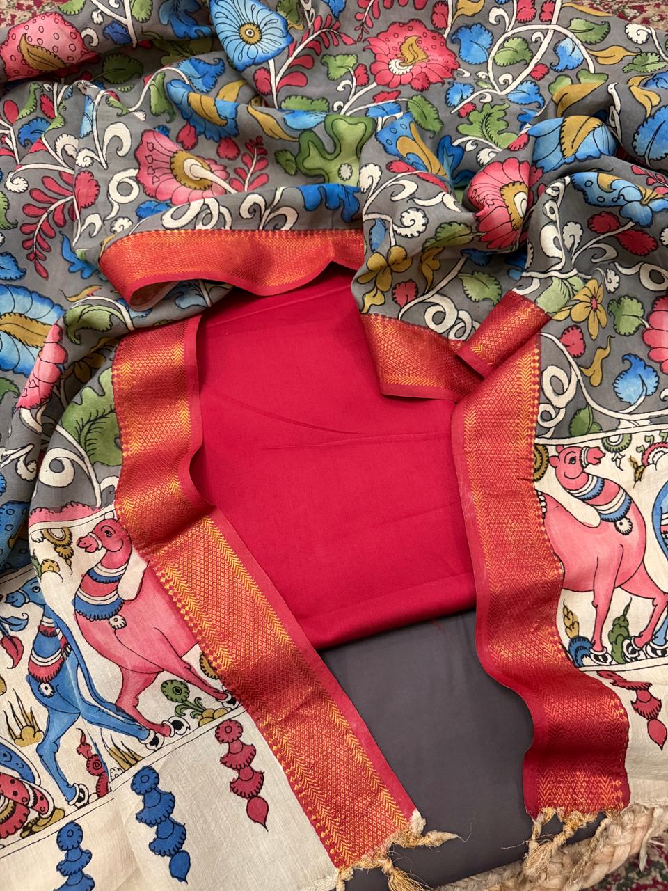 Hand painted Kalamkari dupatta with red and charcoal brown cotton silk 3-piece unstitched suit set – flat lay showing grey floral body and ivory mythological border, House of Tantuvana