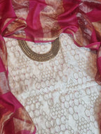 Flat lay of cream and pink Banarasi 2-piece unstitched suit — handwoven Indian handloom fabric