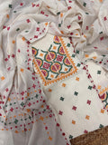 Cream multicolour Sindhi hand-embroidered 3-piece unstitched suit set – kurta, bottom and dupatta flatlay in cotton with green, red and mustard thread work