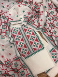 Cream cotton unstitched kurta with dense red and green Sindhi hand embroidery – geometric neckline panel, all-over butti motifs and embroidered dupatta, 3-piece suit set flatlay
