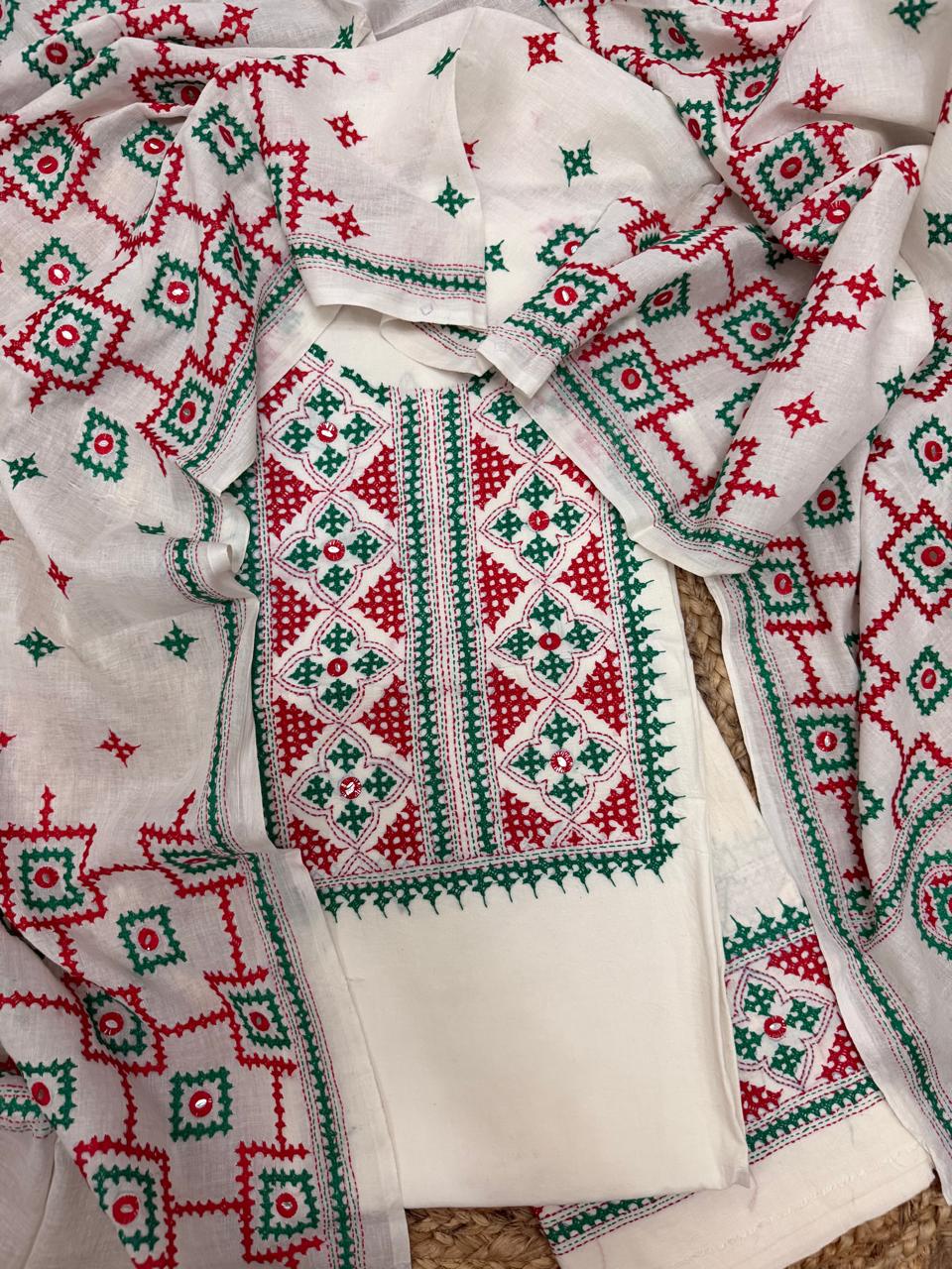 Straight flatlay of cream cotton Sindhi hand-embroidered kurta – bold red and green geometric neckline panel with all-over diamond butti, unstitched 3-piece suit set