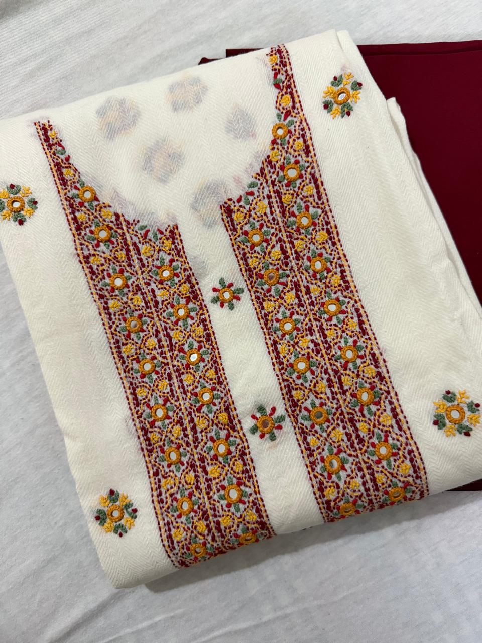 Folded cream cotton kurta fabric with multicolour Kantha hand embroidery and real mirror work – dense floral panel with scattered butti, paired with maroon bottom fabric, unstitched co-ord set